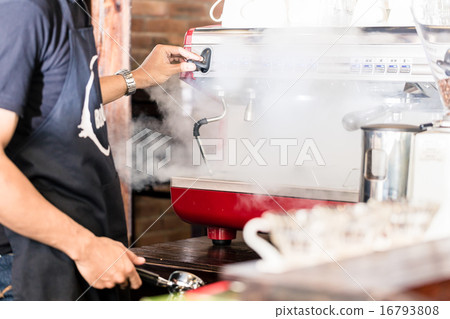 Barista preparing coffee at steaming machine Barista preparing coffee at steaming machine 16793808