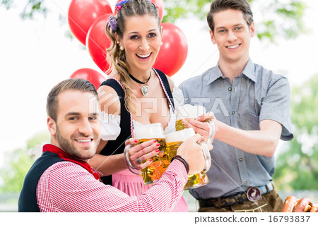 Three friends in Beer garden clinking glasses Three friends in Beer garden clinking glasses 16793837