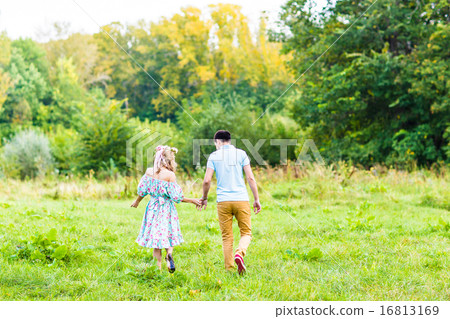 happy couple walking on the meadow 16813169