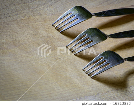Three forks on a wooden board Three forks on a wooden board 16813883