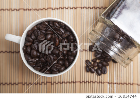Roasted coffee beans in glass and bottle. Roasted coffee beans in glass and bottle. 16814744