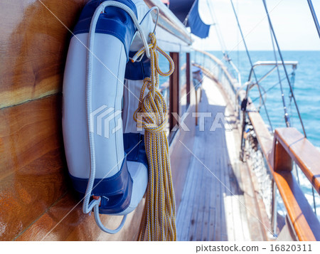 Lifebuoy on the wall of sailboat with rope. Lifebuoy on the wall of sailboat with rope. 16820311
