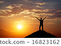 Silhouette of a man on a mountain top.  16823162
