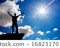 Silhouette of a man on a mountain top. 16823170