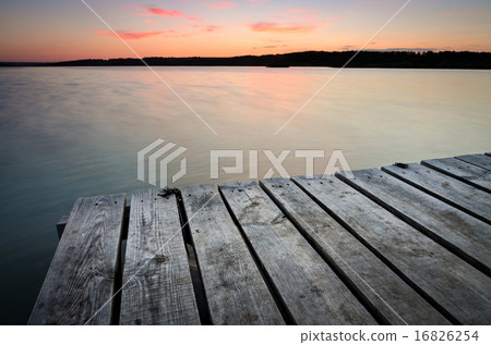 Small wooden pier on big lake at sunset 16826254
