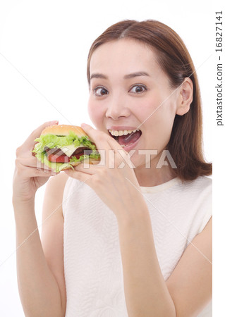 A woman eating a hamburger A woman eating a hamburger 16827141