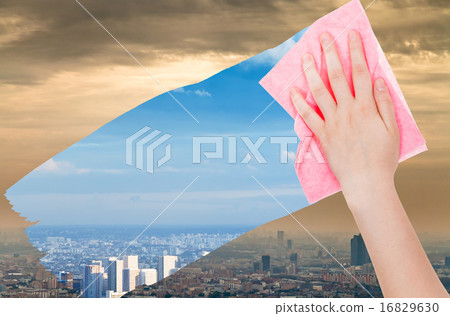 hand deletes smog in city by pink cloth hand deletes smog in city by pink cloth 16829630