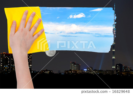 hand deletes night over city by yellow cloth hand deletes night over city by yellow cloth 16829648