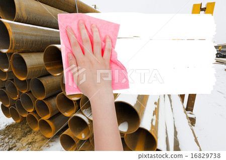 hand deletes industrial landscape by pink rag 16829738