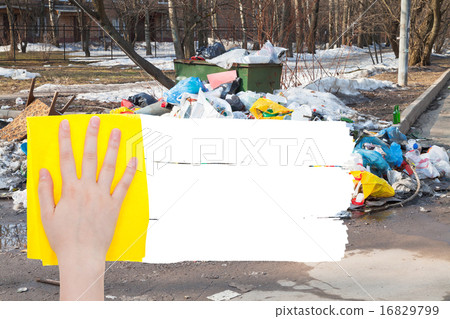 hand deletes outdoor trash by yellow rag hand deletes outdoor trash by yellow rag 16829799