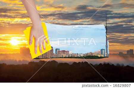 hand deletes yellow sunrise over city by cloth hand deletes yellow sunrise over city by cloth 16829807