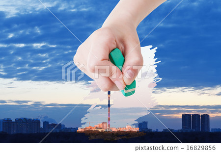 hand deletes sunrise over city by rubber eraser hand deletes sunrise over city by rubber eraser 16829856