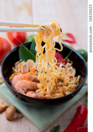 Tom yum kung with noodles on chopsticks handle 16830825