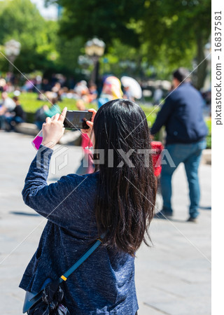 Young woman taking a photo Young woman taking a photo 16837581