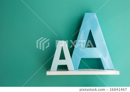 Letters A small and big size turquoise color on a white shelf. Letters A small and big size turquoise color on a white shelf. 16841467
