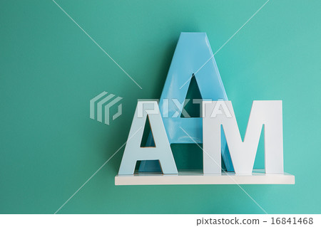 Letters A and M on a white shelf. Letters A and M on a white shelf. 16841468