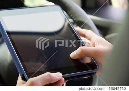 Woman Sitting in the Car and Using digital tablet 16842730
