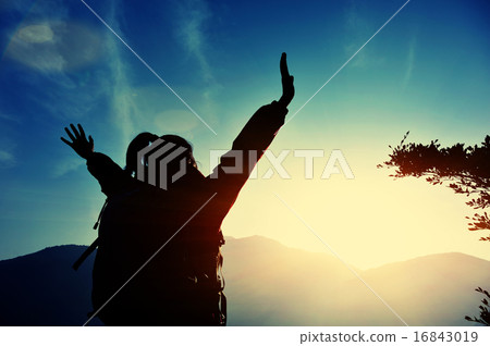 cheering woman hiker open arms at mountain peak cheering woman hiker open arms at mountain peak 16843019