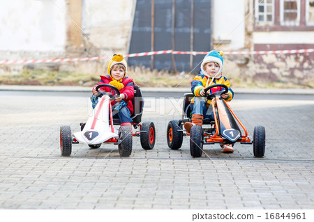 Two little kids boys having fun with toy race cars 16844961