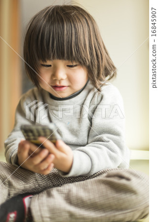 Infant using a smartphone 16845907