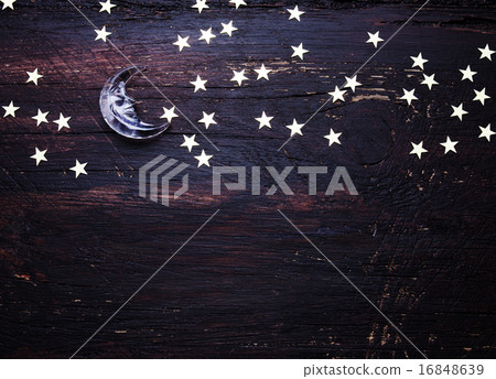 Glitter golden stars and glass moon on grunge wood 16848639