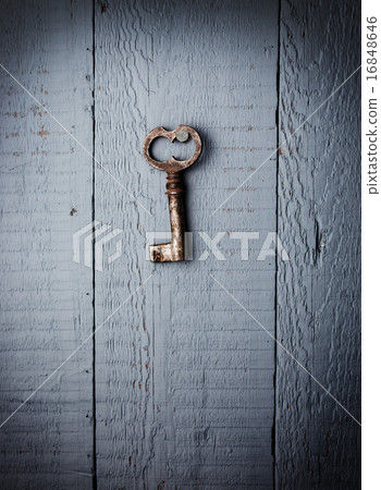Old key hanging on wooden wall Old key hanging on wooden wall 16848646