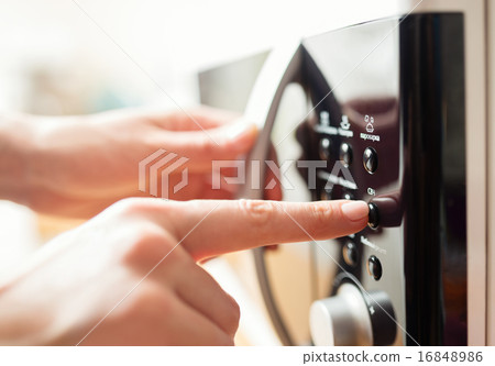 Using microwave oven, close up photo, shallow dof 16848986