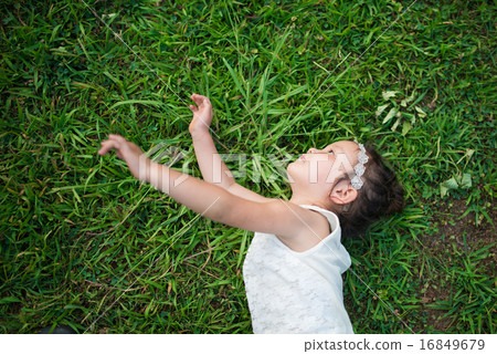 A girl lying down on the meadow A girl lying down on the meadow 16849679
