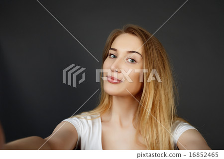 young pretty blonde women taking selfie 16852465