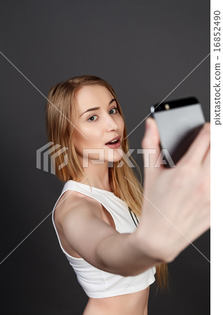 young pretty blonde women taking selfie 16852490