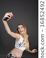 young pretty blonde women taking selfie 16852492