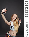 young pretty blonde women taking selfie 16852493