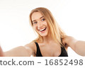young pretty blonde women taking selfie 16852498