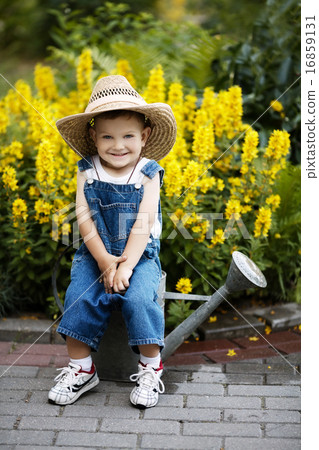 little boy with watering can in summer park little boy with watering can in summer park 16859131
