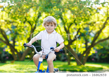 Little preschool kid boy riding with bicycle in summer 16862659