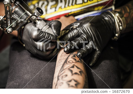 Men putting tattoos in arms Men putting tattoos in arms 16872670