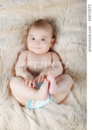 cute baby portrait lying on fur cute baby portrait lying on fur 16872672
