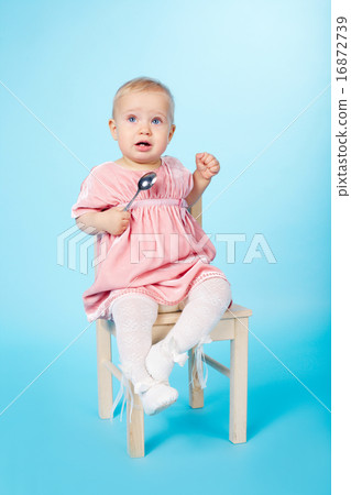 little girl with spoon sitting on chair little girl with spoon sitting on chair 16872739