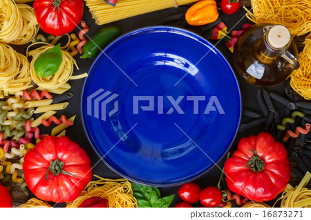 Raw pasta with ingridients and blue plate Raw pasta with ingridients and blue plate 16873271
