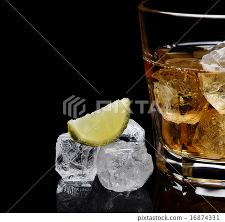 glass of whiskey with ice on a black background glass of whiskey with ice on a black background 16874331