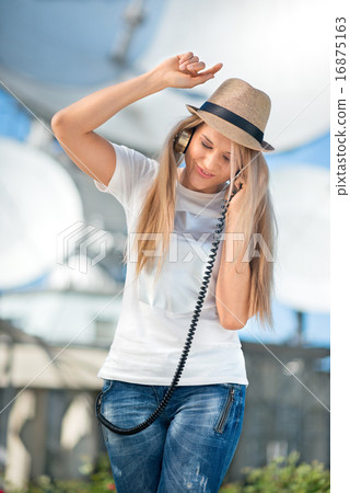 Happy young woman in hat listening to the music in vintage music 16875163
