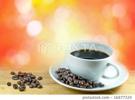Coffee cup and beans on bokeh background Coffee cup and beans on bokeh background 16877320