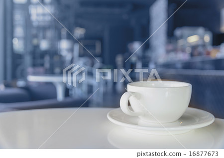 Coffee cup on coffee shop blur background 16877673