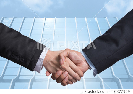 Hand shake between a businessman on Modern glass building backgr 16877909