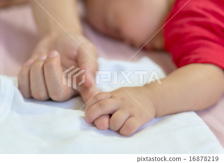Baby hand gently holding mom finger Baby hand gently holding mom finger 16878219