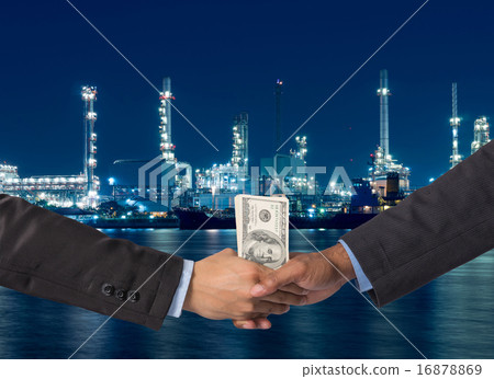 Hand shake between a businessman with dollar money on Petrochemi 16878869