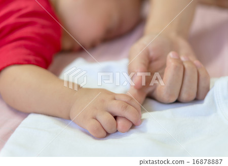 Baby hand gently holding mom finger 16878887