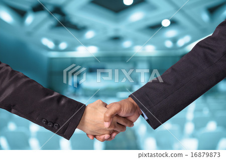 Hand shake between a businessman and a businesswoman o Abstract Hand shake between a businessman and a businesswoman o Abstract 16879873