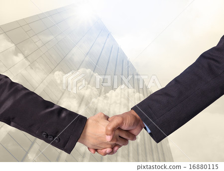 Hand shake between a businessman on Modern glass building with c 16880115