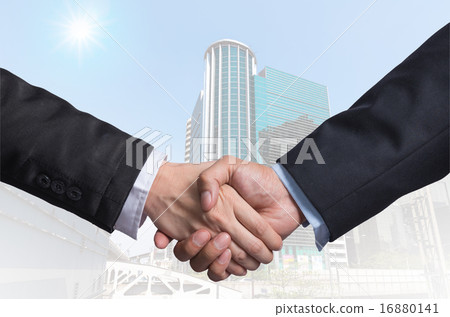 Hand shake between a businessman on Modern business building gla 16880141